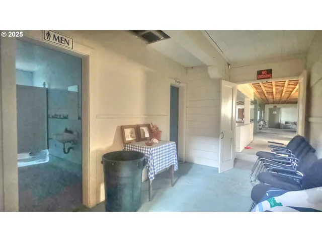 a living room with furniture a flat screen tv and a table