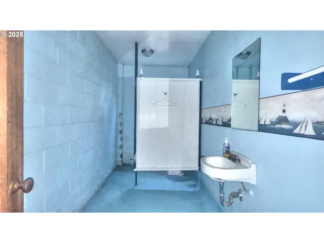 a bathroom with a sink a toilet and mirror