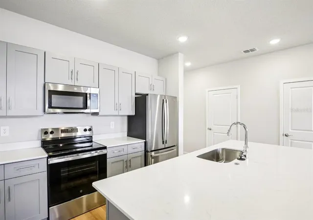 a kitchen with a sink a stove and refrigerator