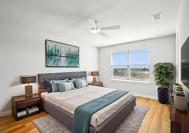 a bedroom with a bed a chandelier and a window