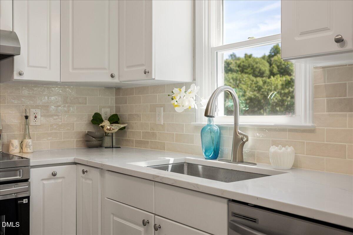 31 Fieldview Court Angier, NC 27501 - Photo 7 of 25 a kitchen with a sink a potted plant and cabinets