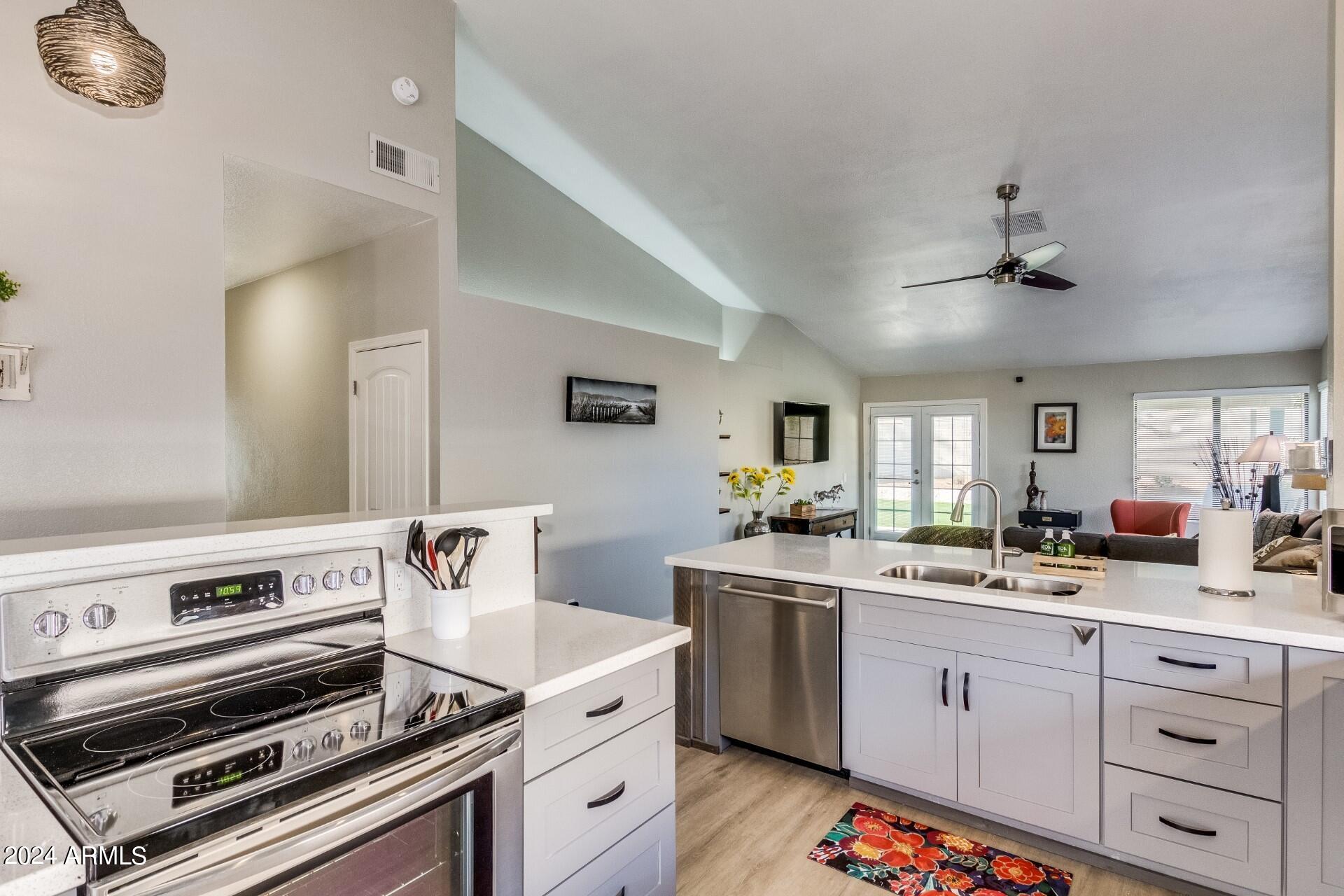 14630 North 44th Street Phoenix, AZ 85032 - Photo 11 of 32 a kitchen with a stove and white cabinets