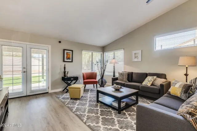 a living room with furniture and a large window