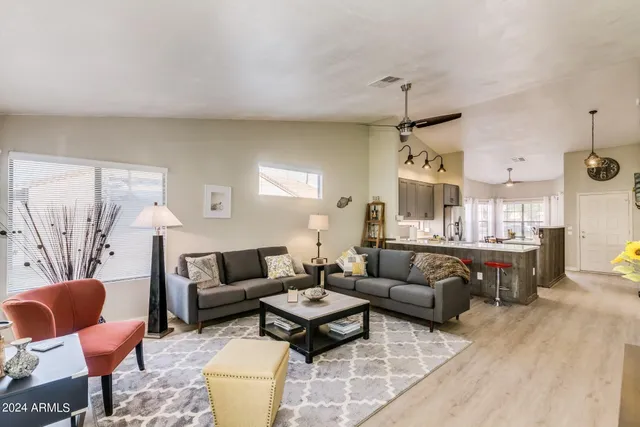 a living room with furniture and a chandelier