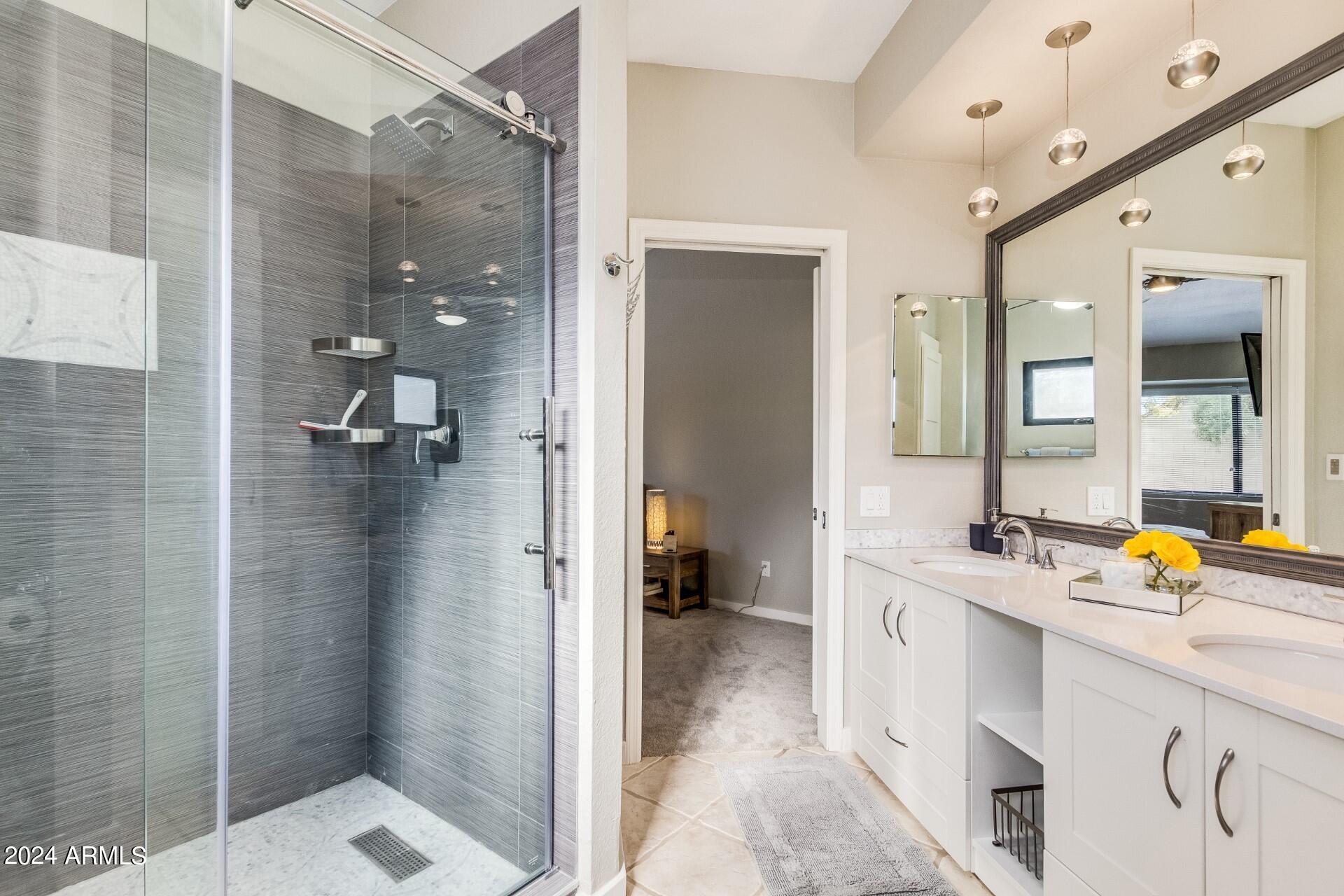 14630 North 44th Street Phoenix, AZ 85032 - Photo 17 of 32 a en suite bathroom with a shower sink and mirror