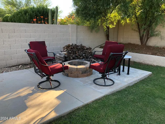 a view of a backyard with table and chairs