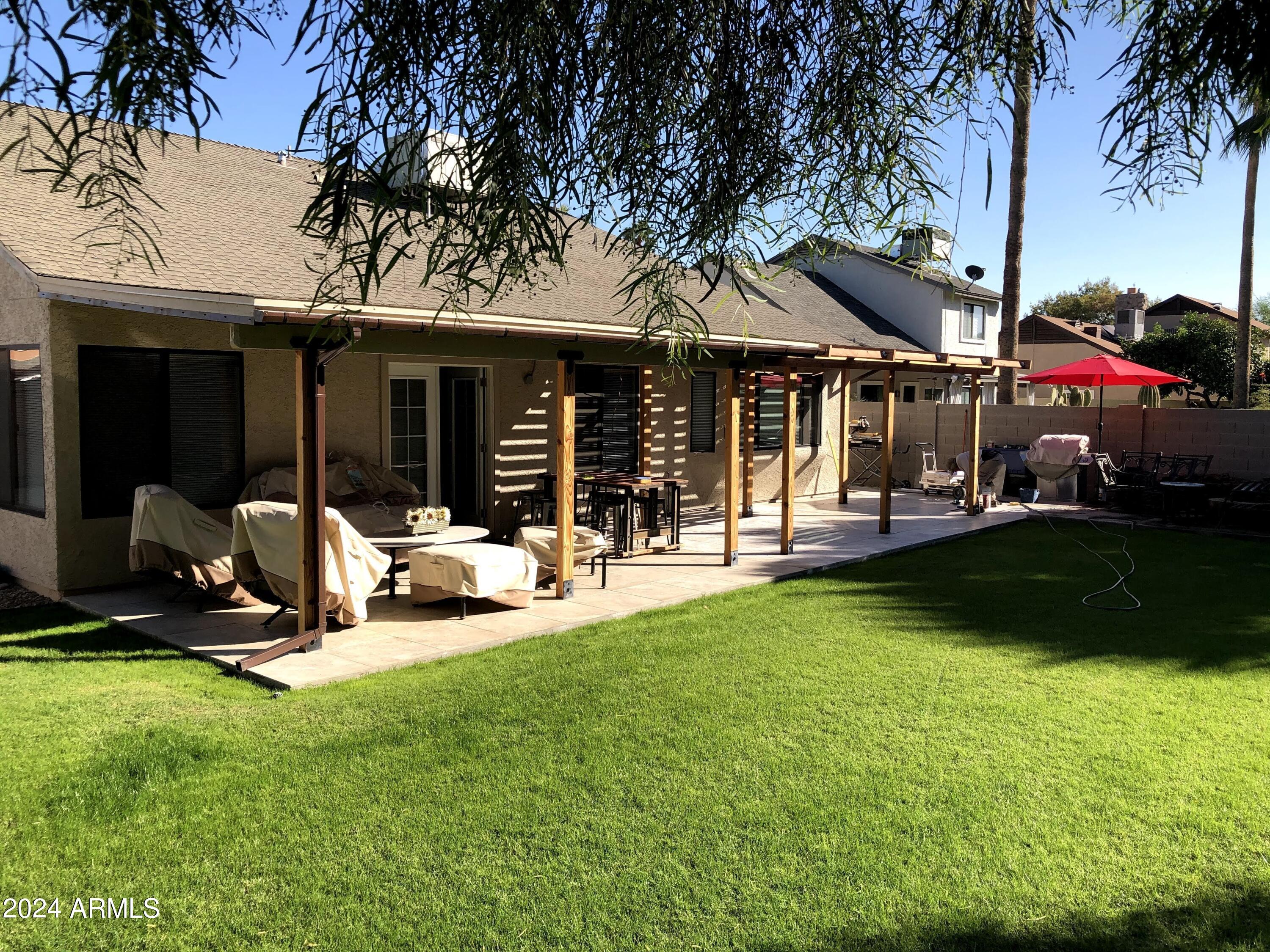 14630 North 44th Street Phoenix, AZ 85032 - Photo 29 of 32 a view of a house with backyard porch and sitting area