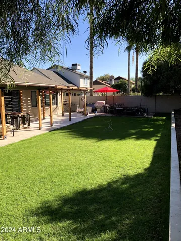 a view of a house with swimming pool and porch