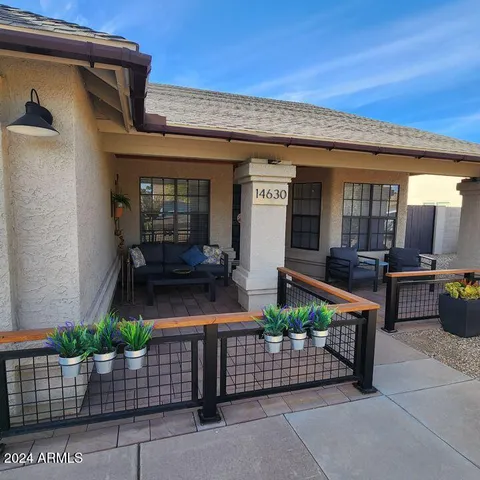 a front view of a house with outdoor seating