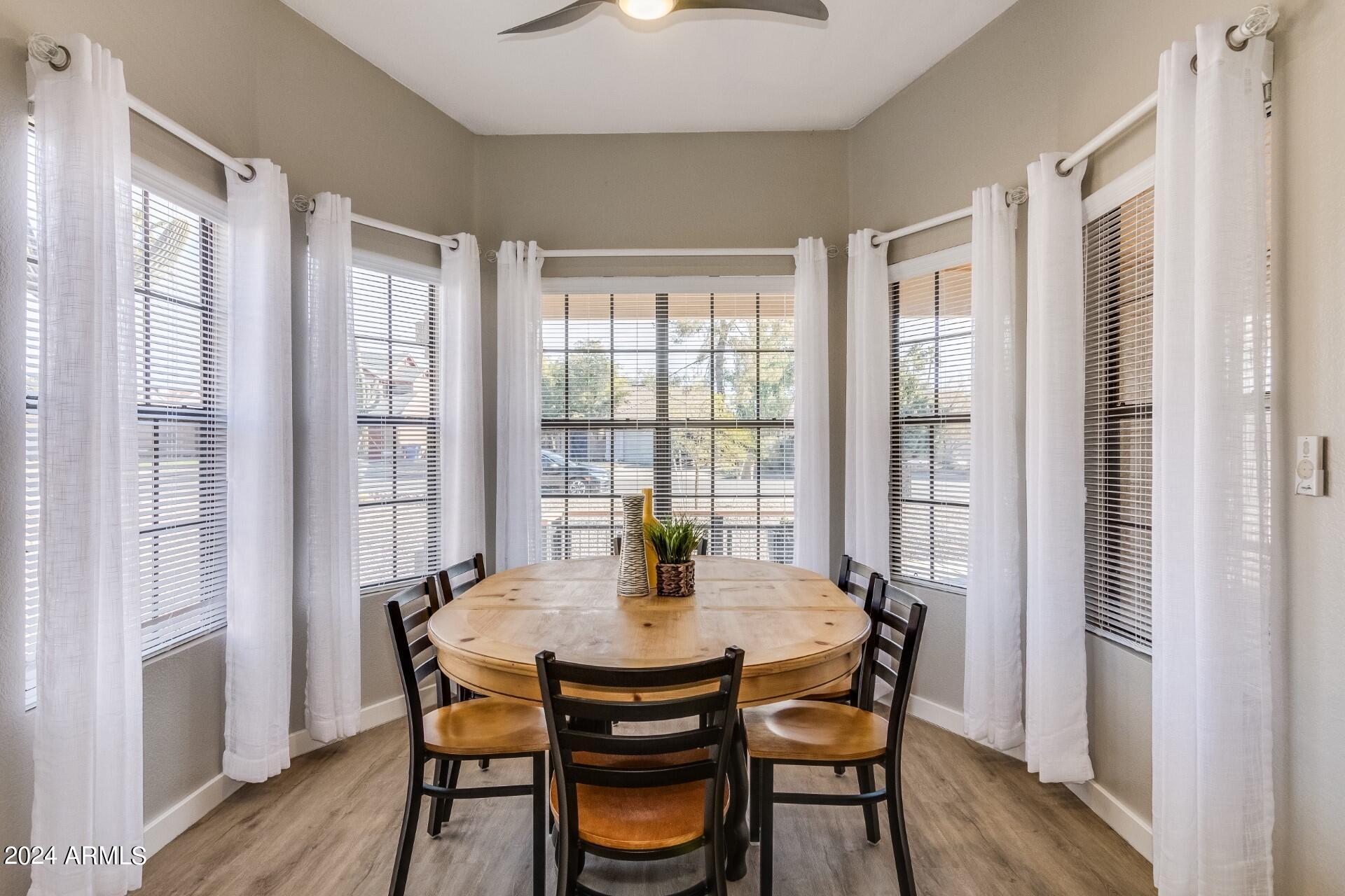 14630 North 44th Street Phoenix, AZ 85032 - Photo 8 of 32 a view of a dining room with furniture window and wooden floor