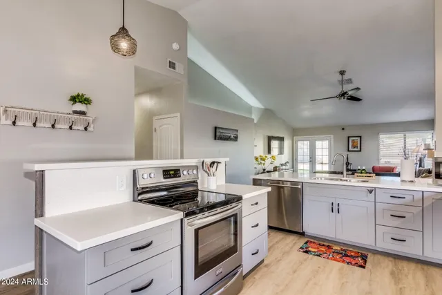 a kitchen with a stove a sink and a refrigerator