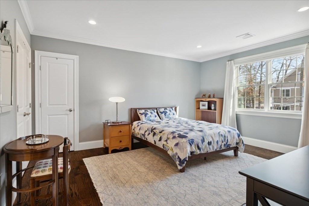64 Clearwater Road Newton, MA 02462 - Photo 23 of 41 a bedroom with a bed and a table in it with window