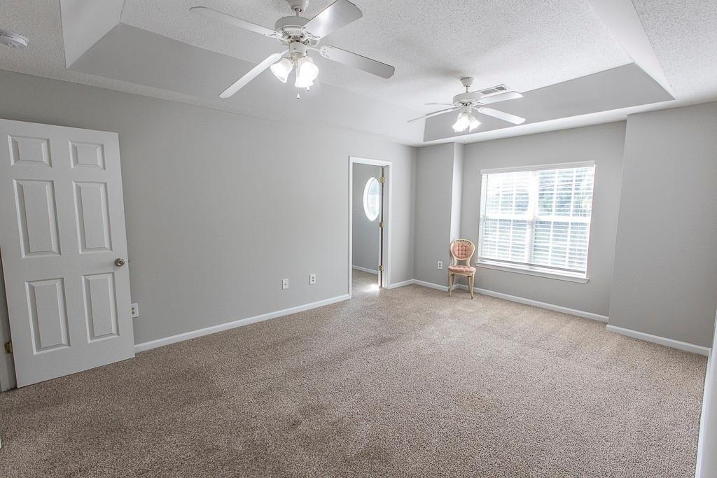 1731 Pryor Road Southwest, Unit 109 Atlanta, GA 30315 - Photo 15 of 34 an empty room with chandelier fan and windows