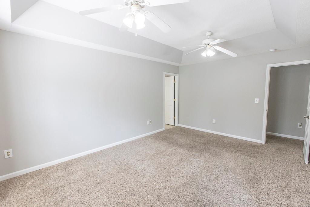 1731 Pryor Road Southwest, Unit 109 Atlanta, GA 30315 - Photo 16 of 34 an empty room with a chandelier fan and a fan