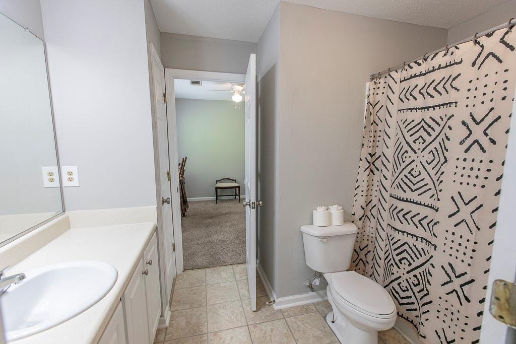 1731 Pryor Road Southwest, Unit 109 Atlanta, GA 30315 - Photo 28 of 34 a bathroom with a granite countertop toilet and a sink