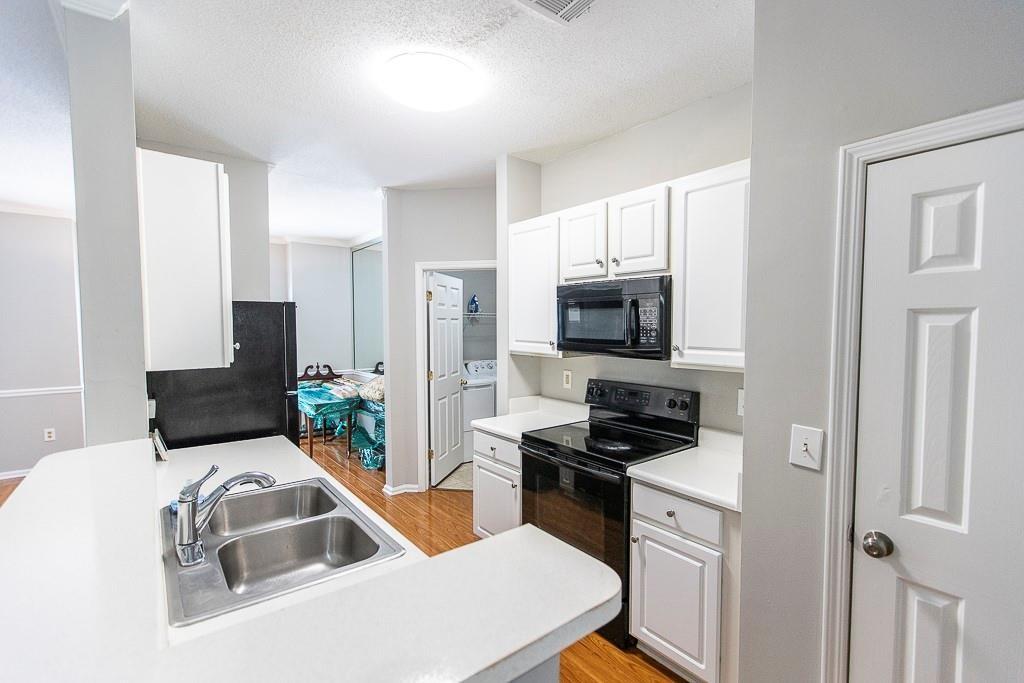 1731 Pryor Road Southwest, Unit 109 Atlanta, GA 30315 - Photo 5 of 34 a kitchen with a sink appliances and cabinets