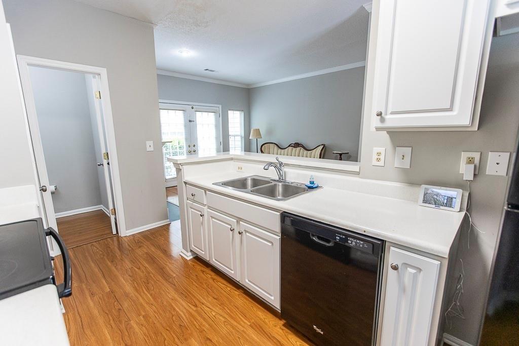 1731 Pryor Road Southwest, Unit 109 Atlanta, GA 30315 - Photo 6 of 34 a kitchen that has a sink a stove and wooden floor