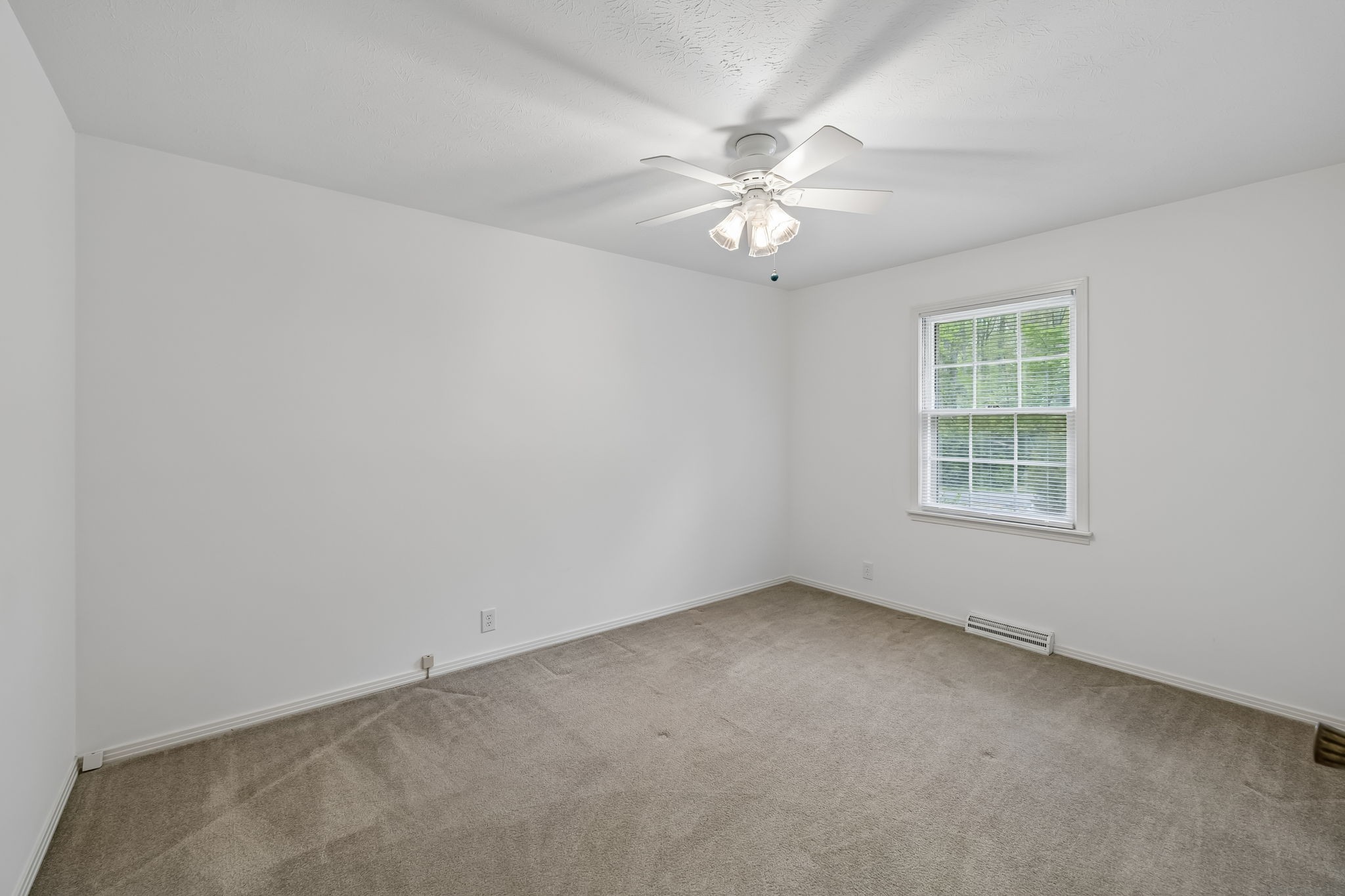 1343 Whiteaker Springs Road Cookeville, TN 38506 - Photo 25 of 48 an empty room with a window and a fan