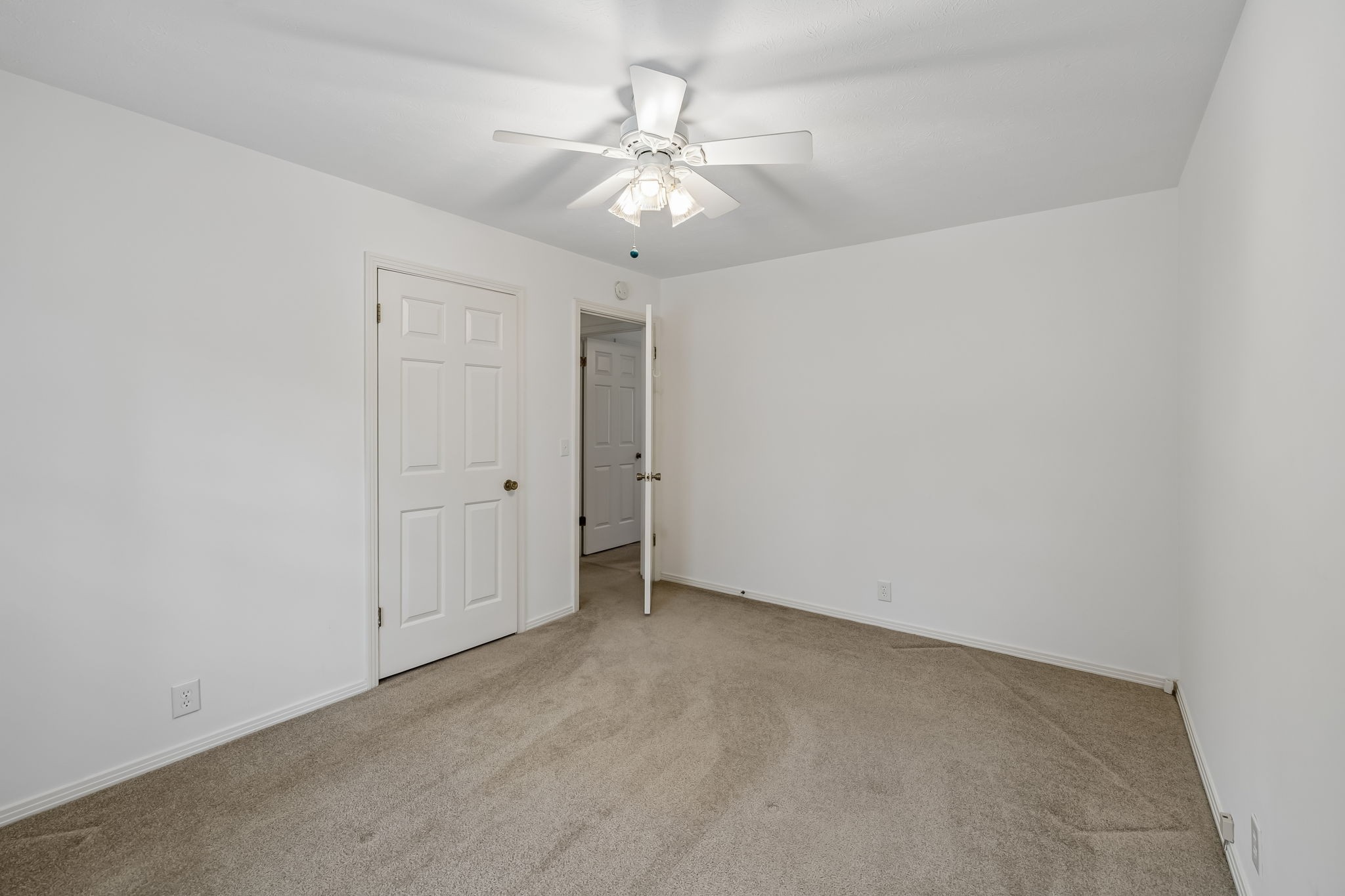 1343 Whiteaker Springs Road Cookeville, TN 38506 - Photo 26 of 48 an empty room with a chandelier fan and windows