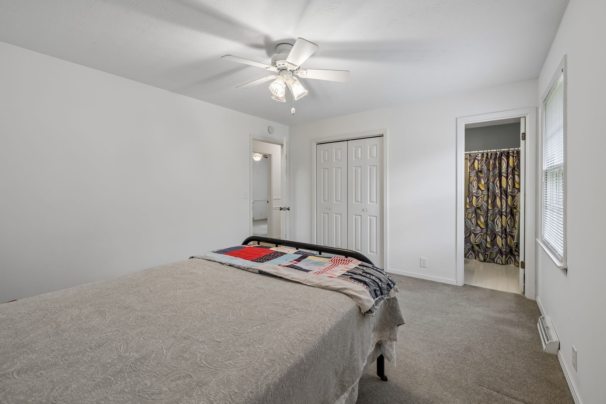 1343 Whiteaker Springs Road Cookeville, TN 38506 - Photo 27 of 48 a bedroom with a bed and a chandelier