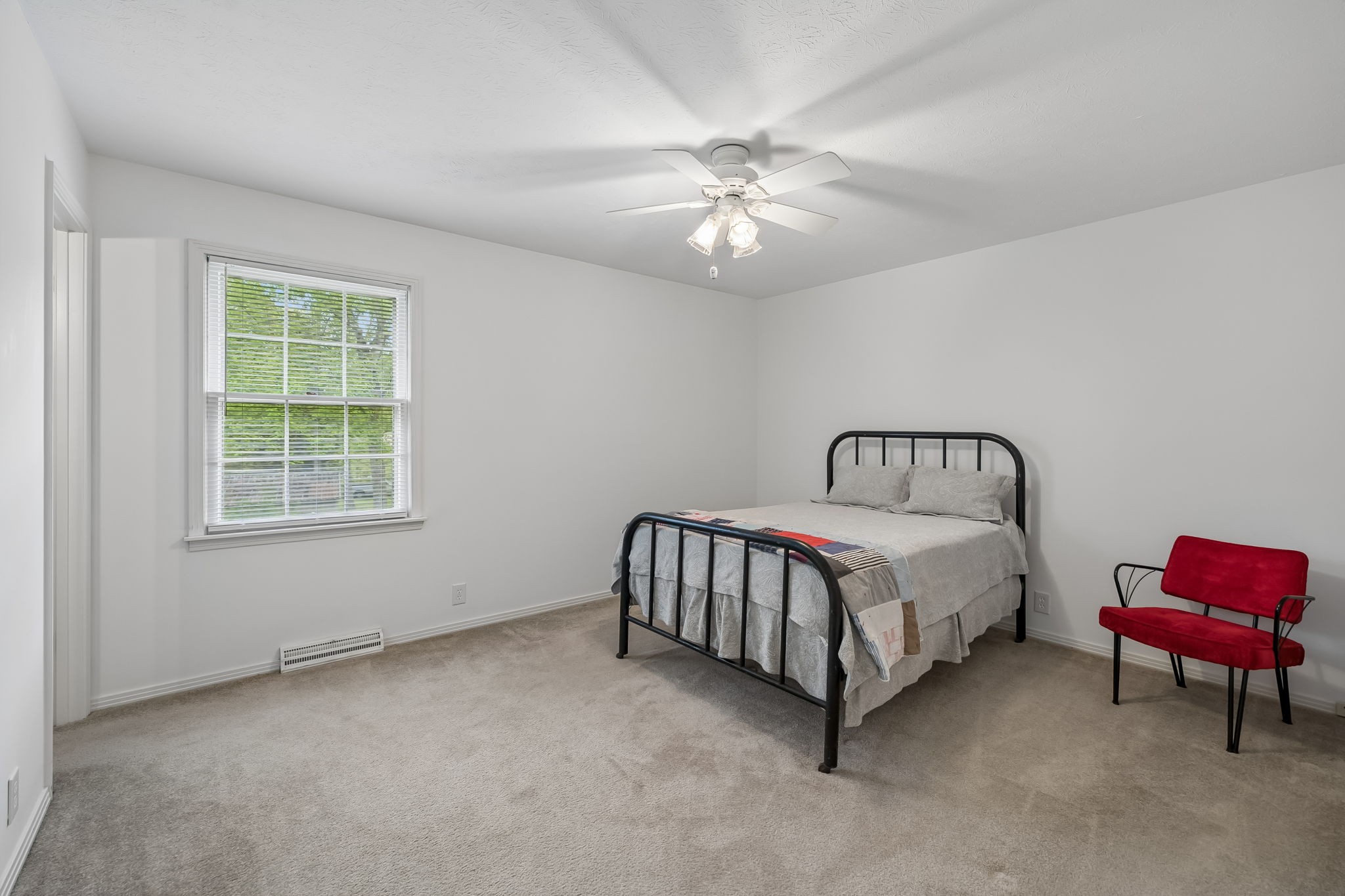 1343 Whiteaker Springs Road Cookeville, TN 38506 - Photo 28 of 48 a spacious bedroom with a bed and a chandelier