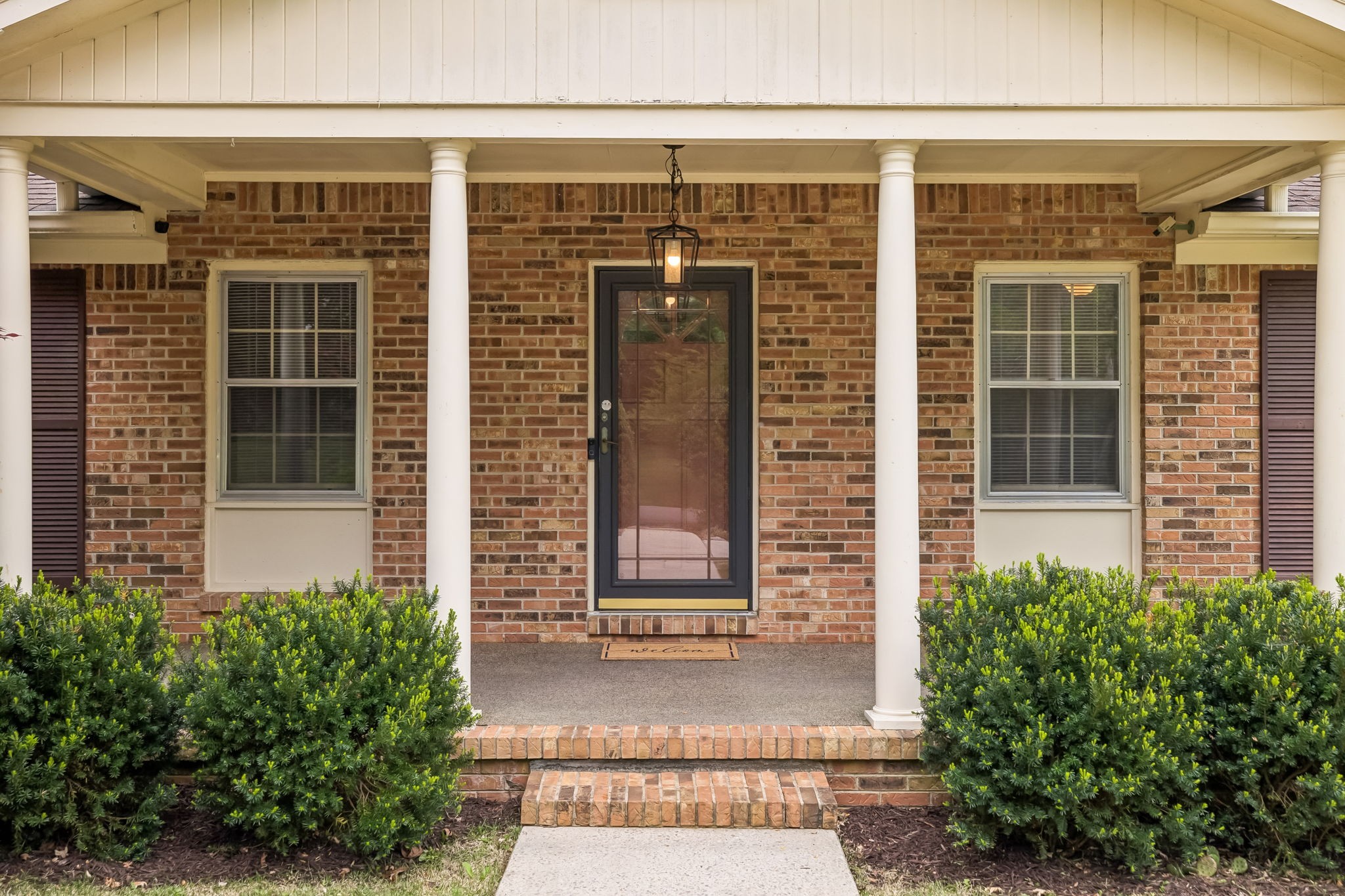 1343 Whiteaker Springs Road Cookeville, TN 38506 - Photo 48 of 48 front view of a brick house with a large window and potted plants