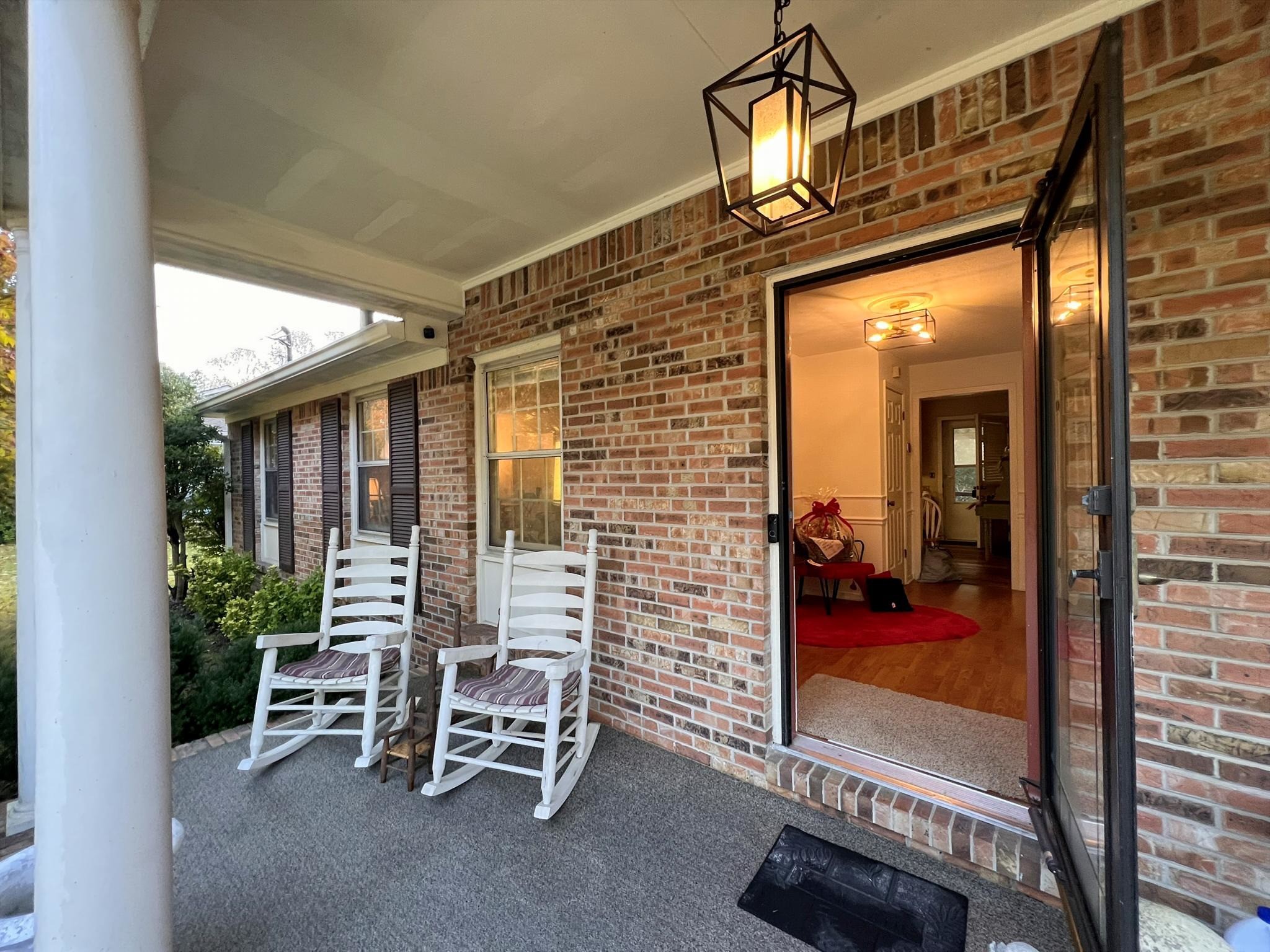 1343 Whiteaker Springs Road Cookeville, TN 38506 - Photo 7 of 48 a view of a porch with a table and chairs
