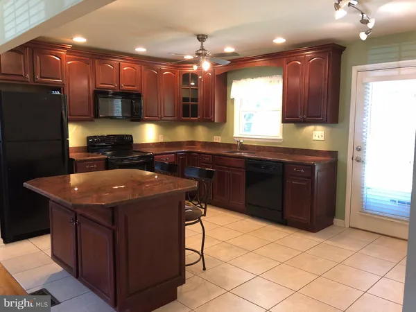 a kitchen with stainless steel appliances granite countertop a sink counter space cabinets and a counter top space