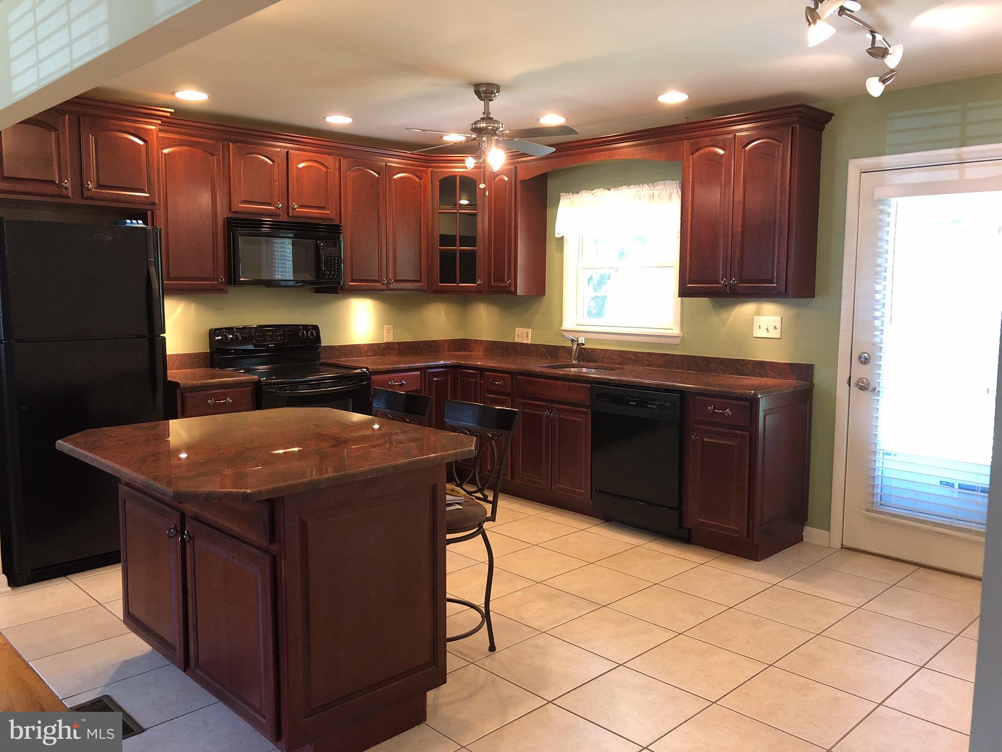 106 Boyd Drive Annapolis, MD 21403 - Photo 3 of 7 a kitchen with stainless steel appliances granite countertop a sink counter space cabinets and a counter top space