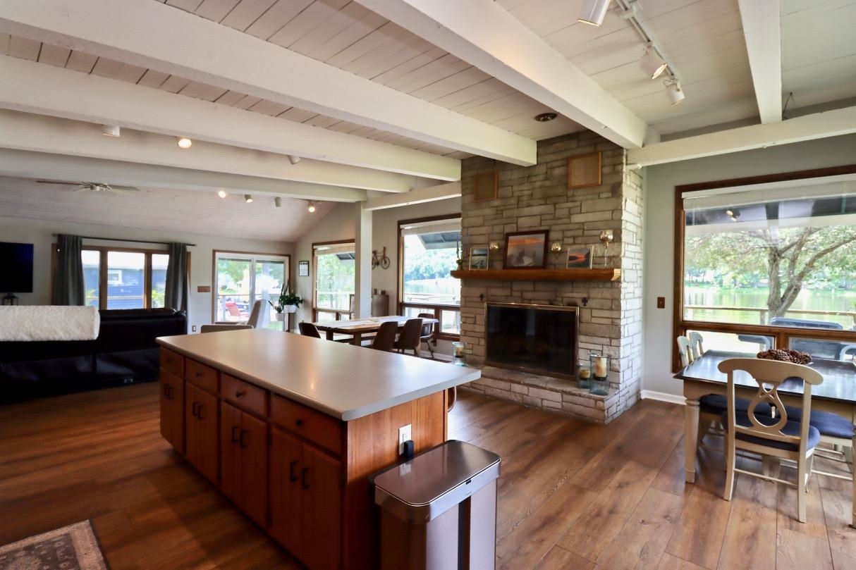 2870 South Riverside Drive Beloit, WI 53511 - Photo 18 of 32 a large living room with stainless steel appliances granite countertop furniture wooden floor a fireplace and a large window