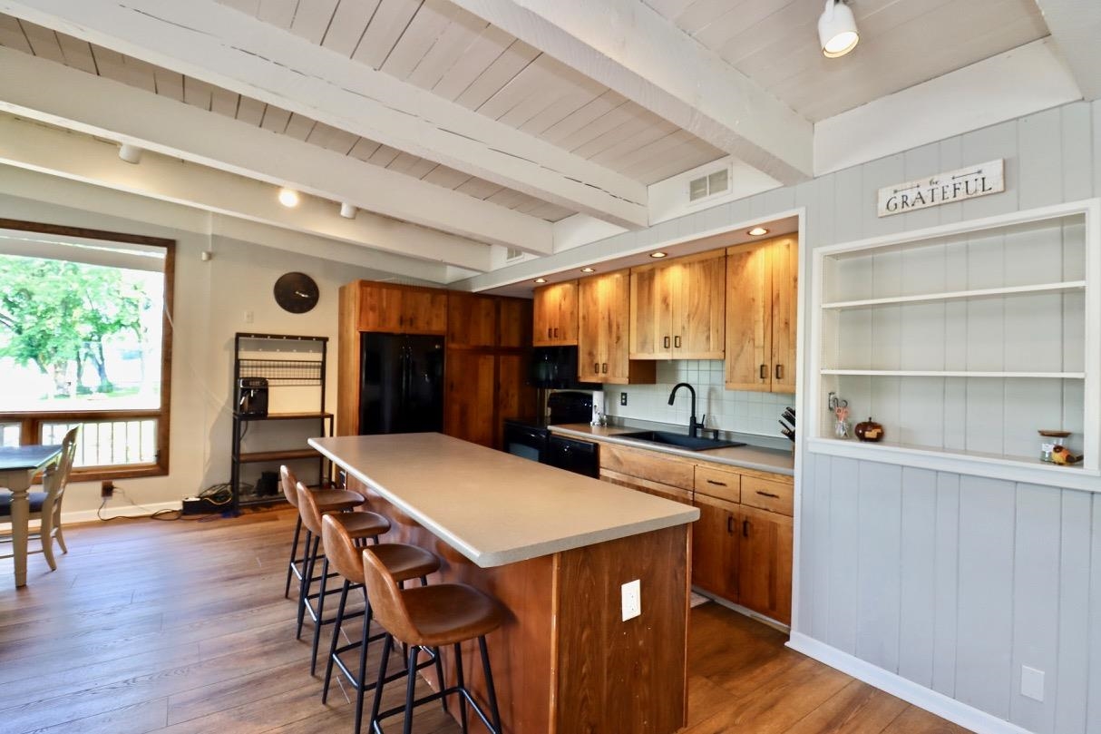 2870 South Riverside Drive Beloit, WI 53511 - Photo 20 of 32 a kitchen with a table chairs refrigerator and cabinets