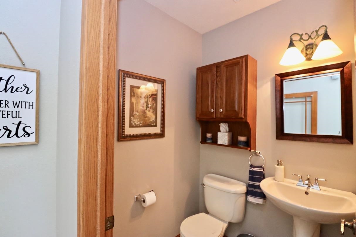 2870 South Riverside Drive Beloit, WI 53511 - Photo 26 of 32 a bathroom with a toilet a sink and mirror