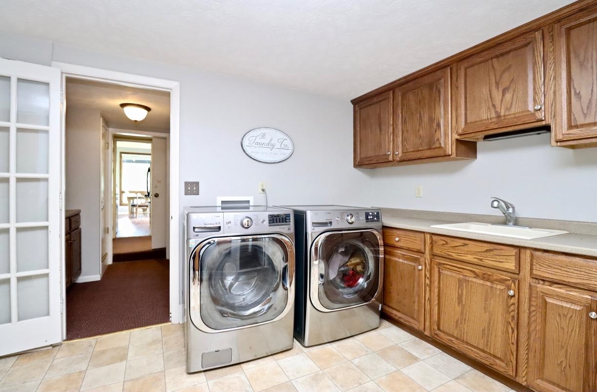 2870 South Riverside Drive Beloit, WI 53511 - Photo 27 of 32 a utility room with sink dryer and washer
