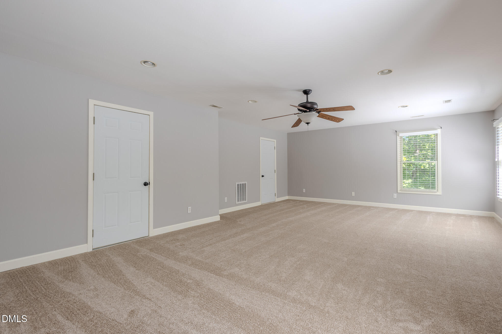 2729 Sunnystone Way Raleigh, NC 27613 - Photo 23 of 37 a view of a livingroom with a ceiling fan and window