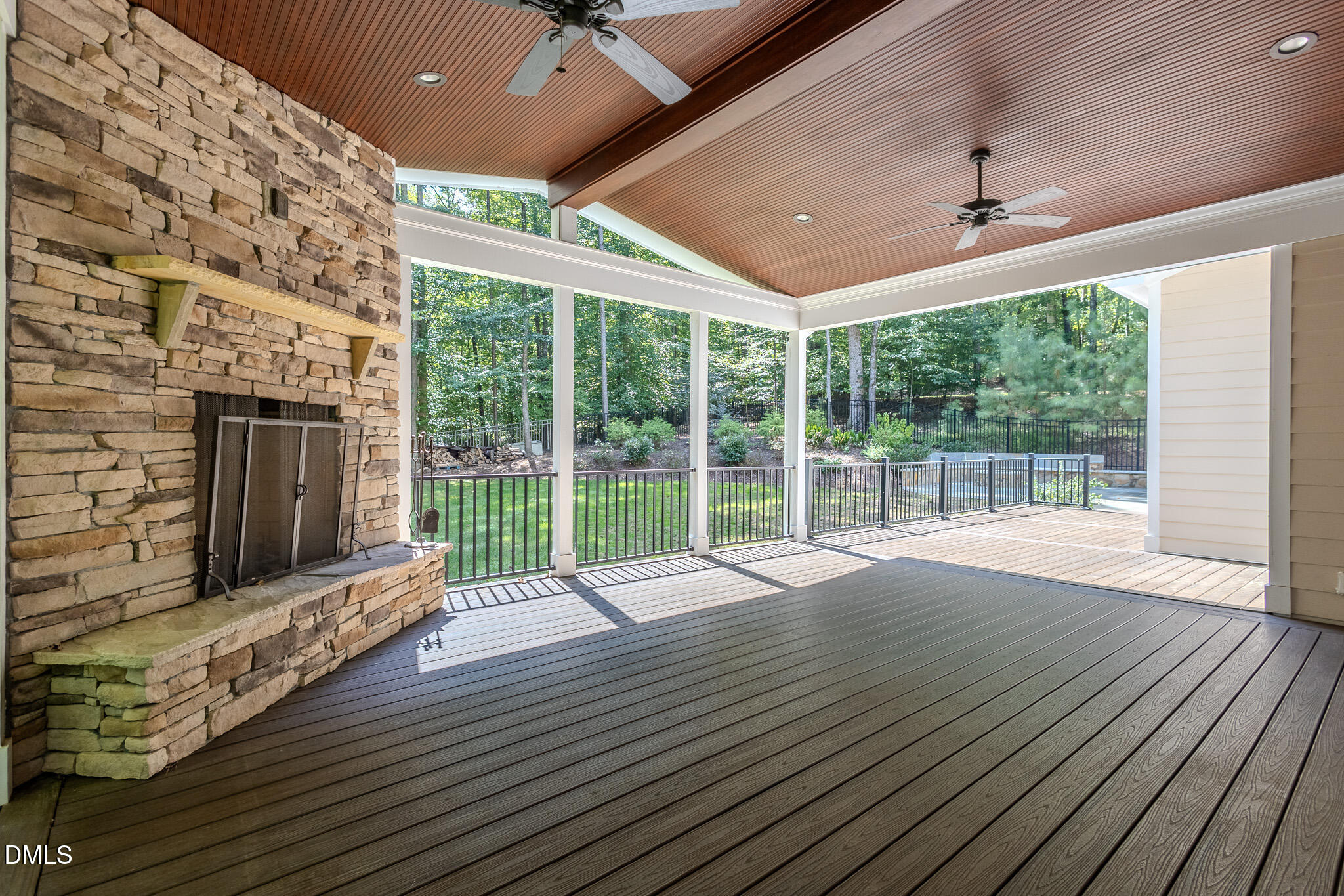 2729 Sunnystone Way Raleigh, NC 27613 - Photo 26 of 37 a view of an empty room with wooden floor and a fireplace