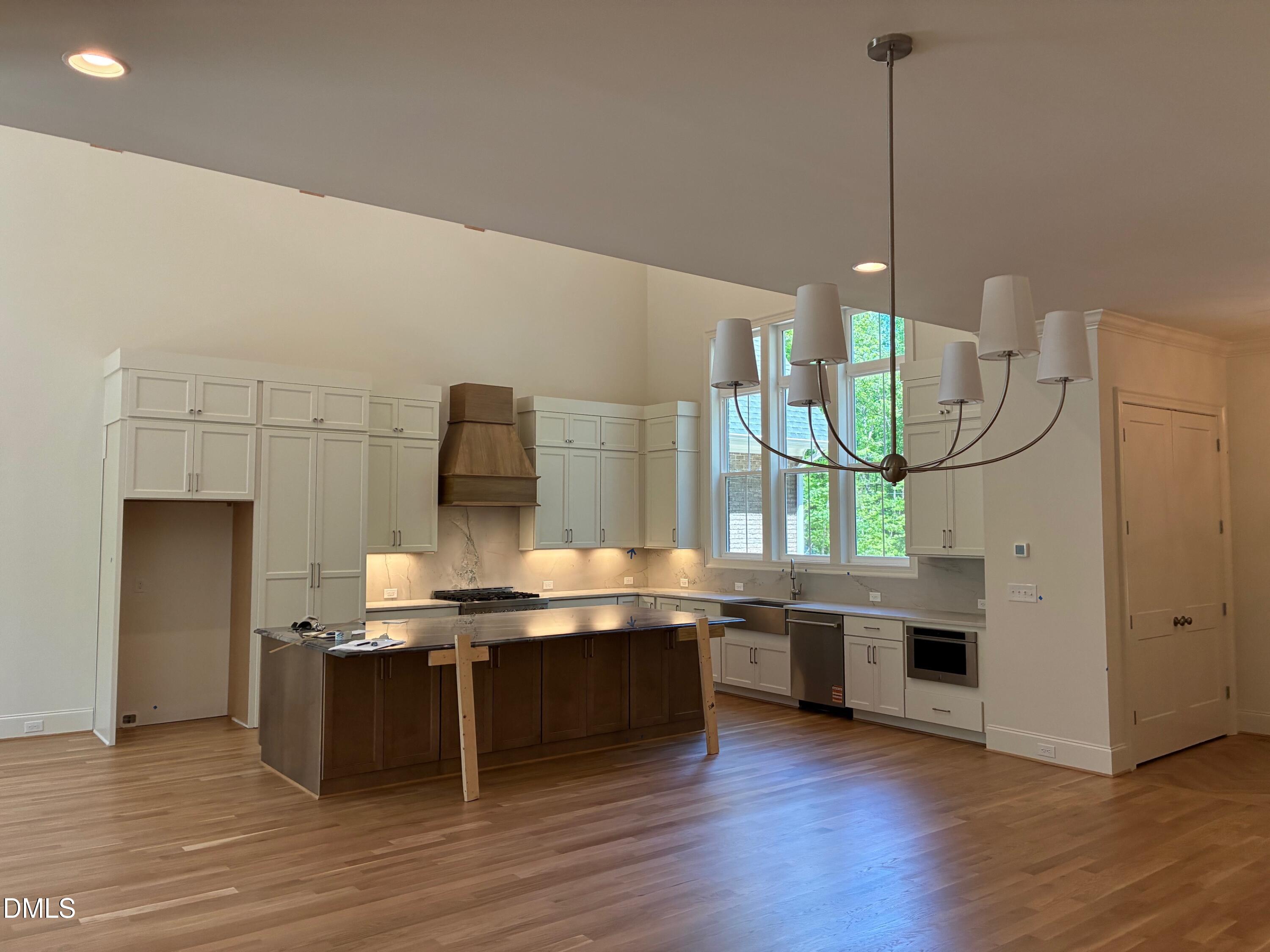 638 Old Goldston Road Pittsboro, NC 27312 - Photo 16 of 28 a room with kitchen island stainless steel appliances a stove and wooden floor