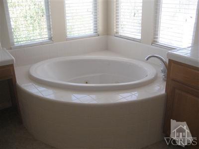 5813 Indian Pointe Drive Simi Valley, CA 93063 - Photo 16 of 25 a white bath tub sitting in a bathroom