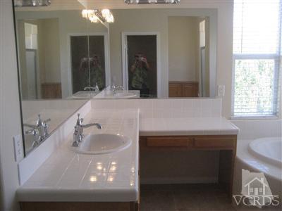 5813 Indian Pointe Drive Simi Valley, CA 93063 - Photo 17 of 25 a bathroom with a sink and a mirror
