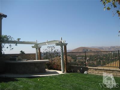 5813 Indian Pointe Drive Simi Valley, CA 93063 - Photo 20 of 25 a view of a deck with a big yard and large trees