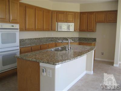 5813 Indian Pointe Drive Simi Valley, CA 93063 - Photo 6 of 25 a kitchen with stainless steel appliances granite countertop a sink stove and cabinets