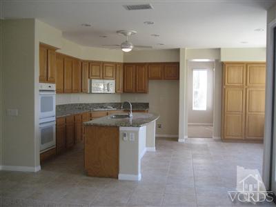 5813 Indian Pointe Drive Simi Valley, CA 93063 - Photo 7 of 25 a kitchen with a sink stove and cabinets