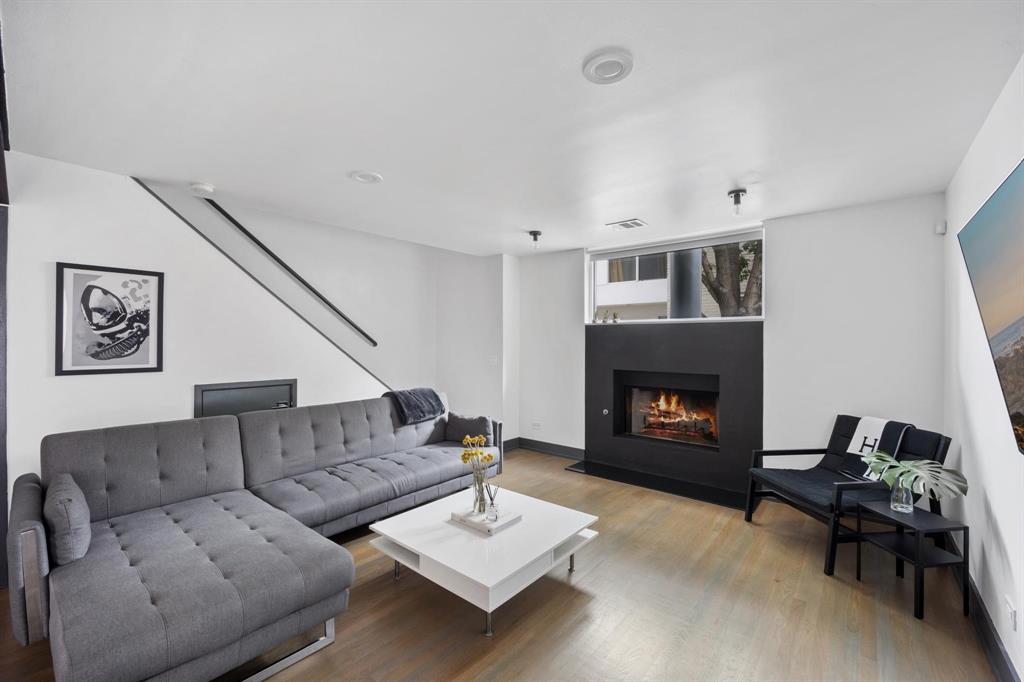 4134 Travis Street, Unit 11 Dallas, TX 75204 - Photo 1 of 29 a living room with furniture and a fireplace