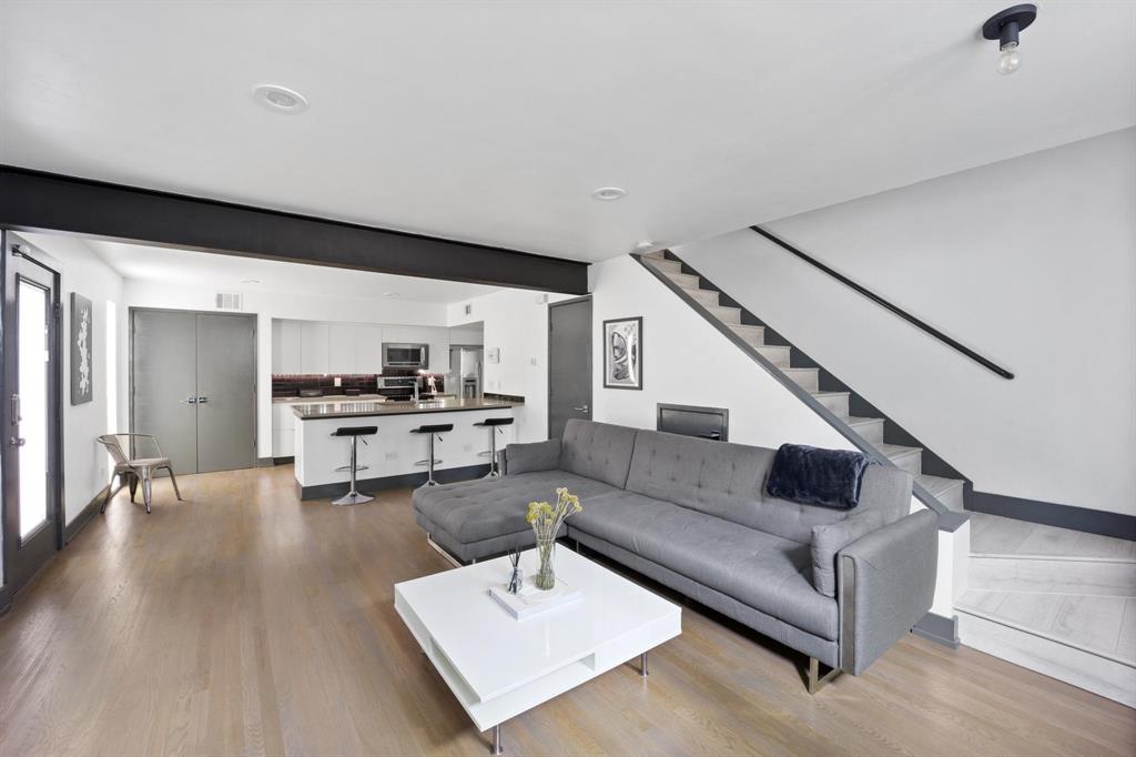 4134 Travis Street, Unit 11 Dallas, TX 75204 - Photo 13 of 29 a living room with furniture and wooden floor