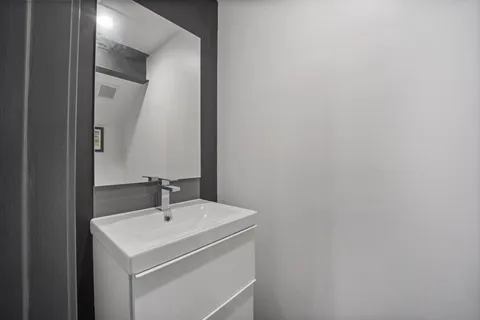 a white toilet sitting next to a bathroom sink