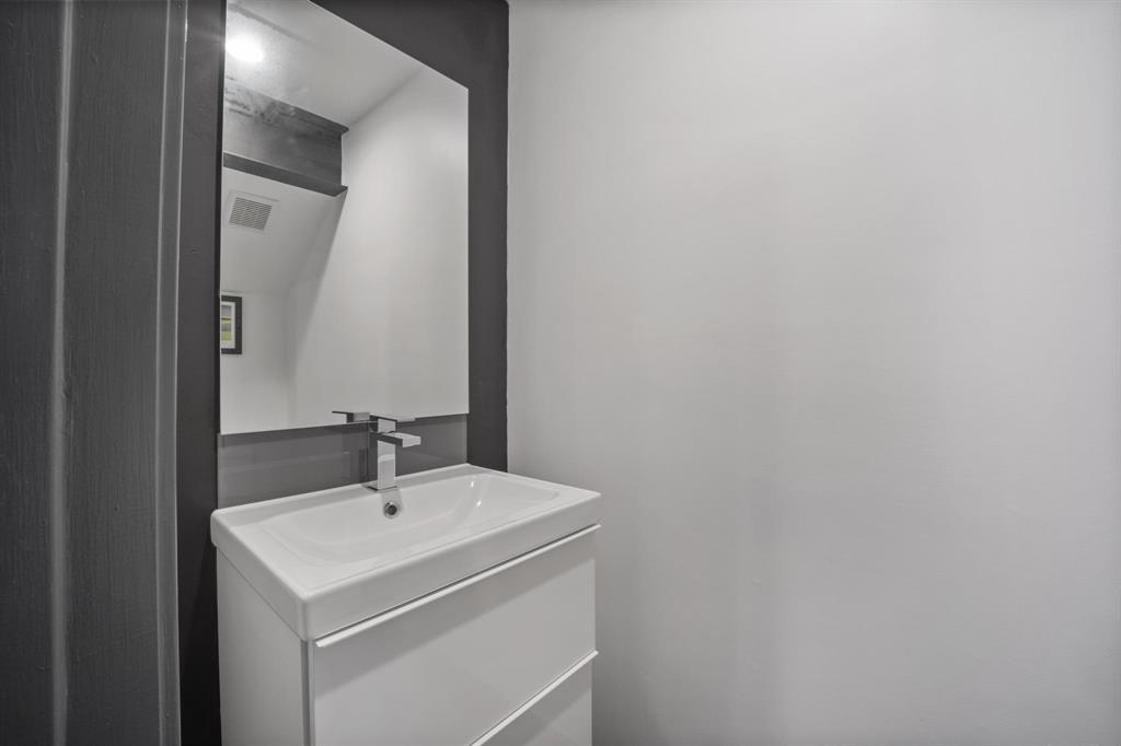 4134 Travis Street, Unit 11 Dallas, TX 75204 - Photo 14 of 29 a bathroom with a sink and a mirror