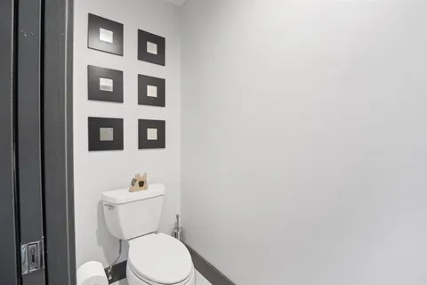 a bed sitting in a spacious bedroom next to a window