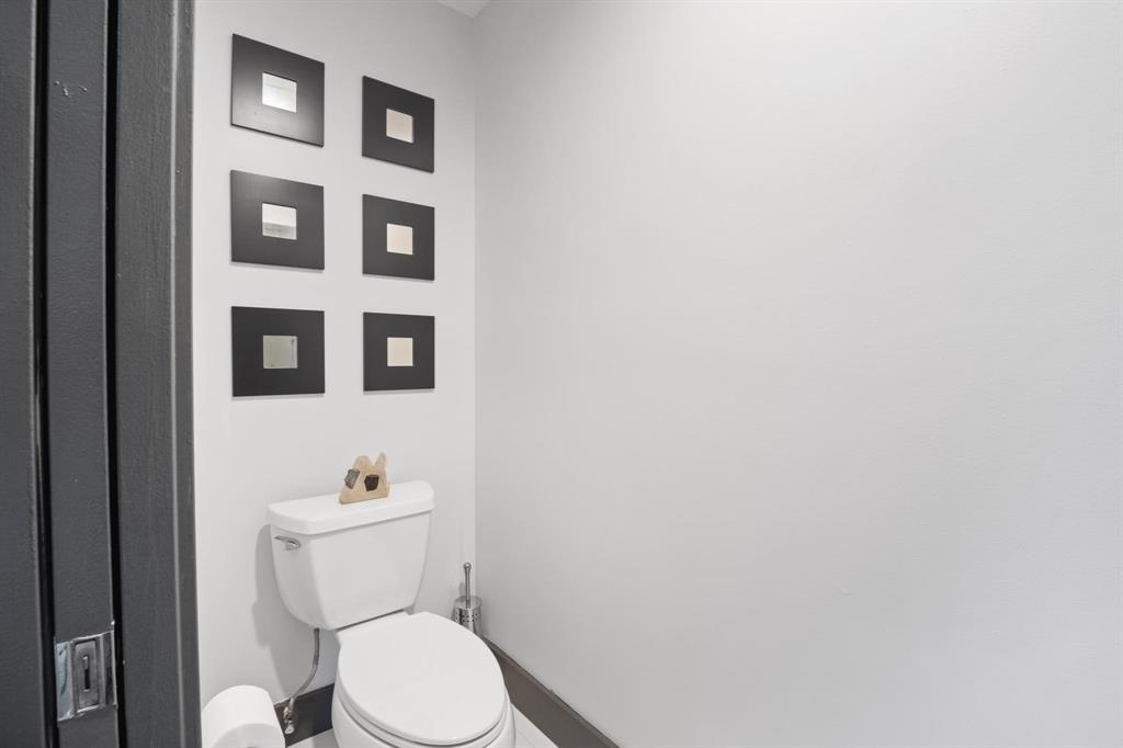 4134 Travis Street, Unit 11 Dallas, TX 75204 - Photo 15 of 29 a white toilet sitting next to a bathroom sink