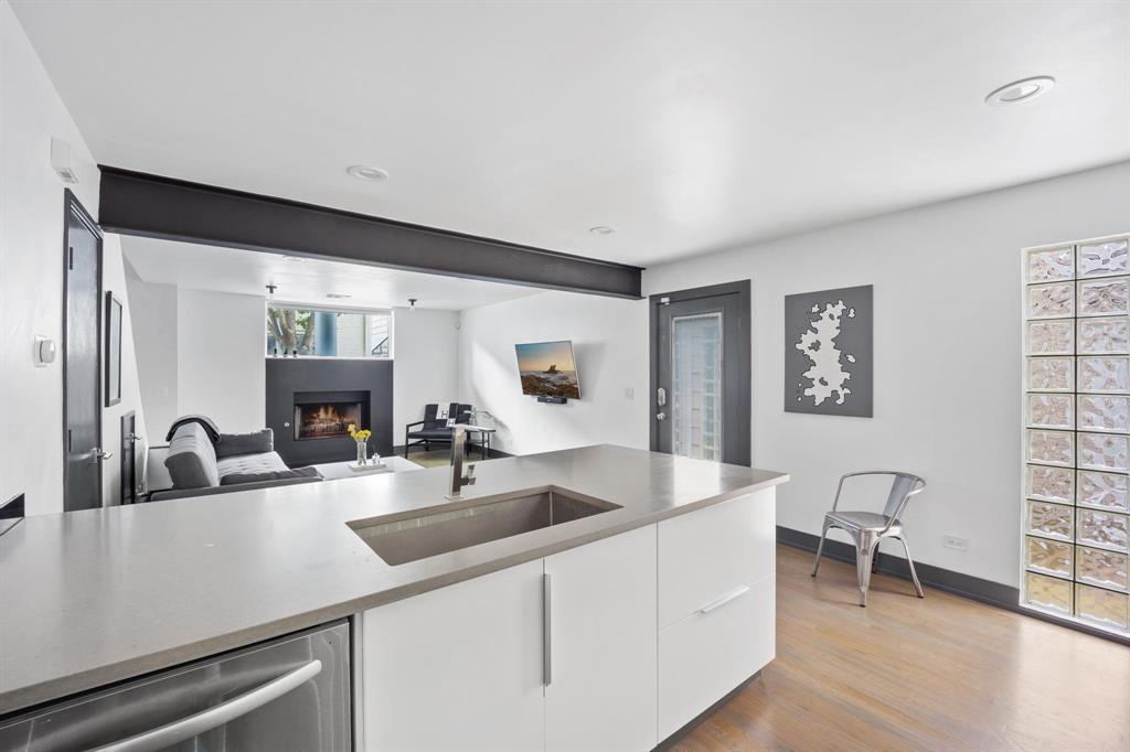 4134 Travis Street, Unit 11 Dallas, TX 75204 - Photo 18 of 29 a kitchen with a sink cabinets and wooden floor