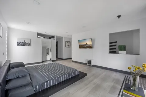 a bedroom with a large bed and a window