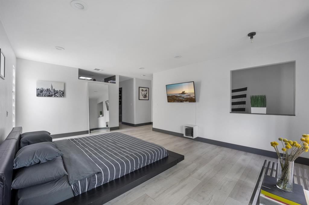 4134 Travis Street, Unit 11 Dallas, TX 75204 - Photo 19 of 29 a bedroom with a bed and a dresser